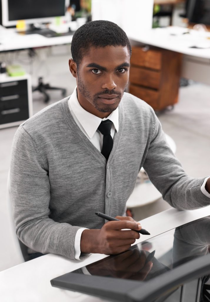 Smart technology makes everything easier. A young man working on a large touchscreen.